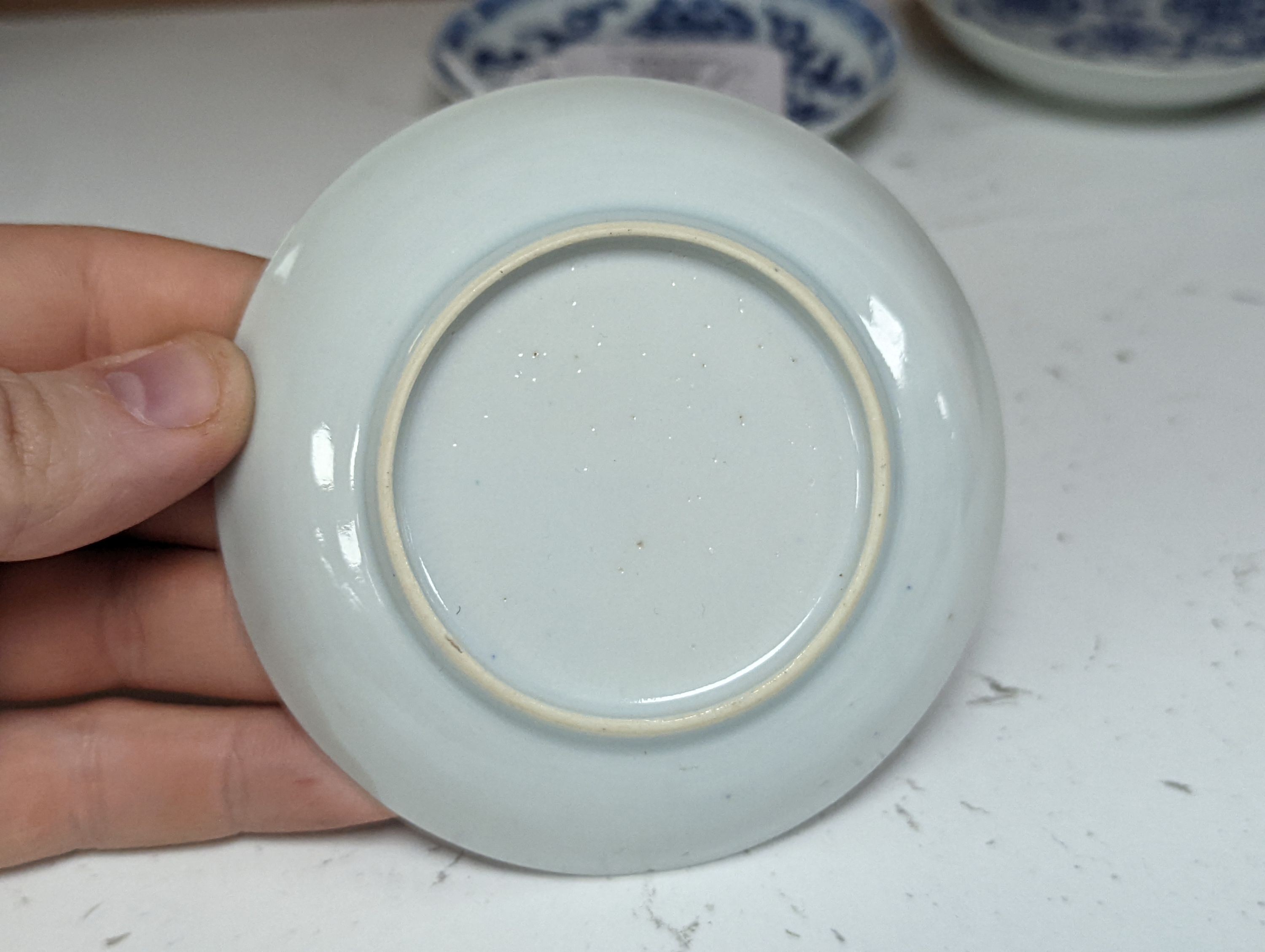 Seven 18th century Chinese saucer dishes, largest 14 cms diameter.